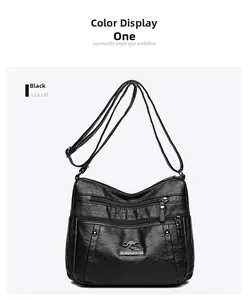 Detail of black PU leather shoulder bag featuring multi-zipper pockets and litchi texture