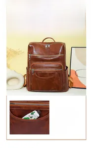 Detail of a brown leather backpack featuring a front half moon pouch for small items
