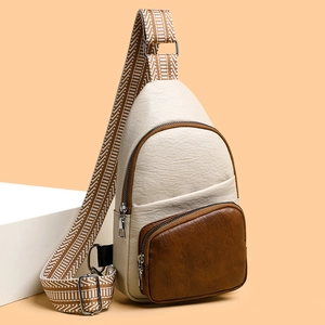 Vintage cream leather crossbody chest bag with geometric woven strap on minimalist display
