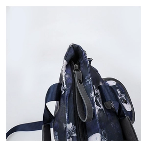Close-up of navy blue skull print tote bag with durable metal zippers and nylon handles