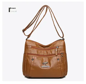 Close-up of brown PU leather shoulder bag featuring three zipper pockets and kangaroo logo
