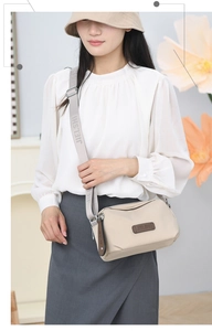Beige nylon crossbody bag with adjustable JIELSHI strap on female model