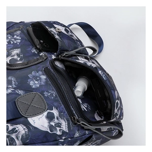 Detail of multi-pocket storage in blue skull print tote with phone and power bank