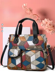 Detail of multi-color geometric pattern faux leather handbag with front zip and flap pockets
