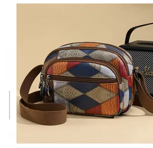 Detailed view of retro patchwork crossbody bag with multi-zipper layers and woven strap