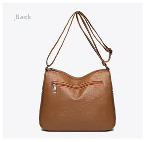 Detail view of the brown PU leather shoulder bag featuring a functional back zipper pocket