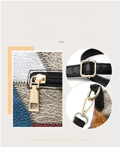 Detail of premium gold hardware zippers and multi-colored lychee textured leather bag