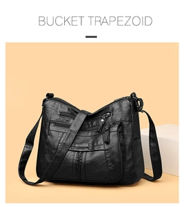 Detail of black washed soft leather crossbody bag with multiple zipper pockets
