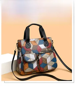 Detail of colorful geometric 3D cube print on vintage washed leather shoulder bag