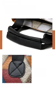 Detail of reinforced stitching and soft washed leather handle on a vintage motorcycle bag