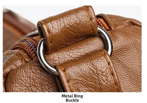 Close-up of metal buckle and decorative stitching on brown pebble grain faux leather bag