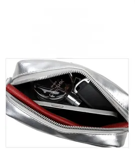 Detailed interior of silver cross-body bag showing large capacity for phone and accessories