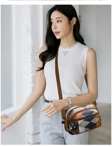 Detail of color-block crossbody bag with animal texture leather and wide woven strap