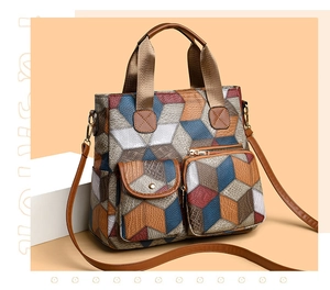 Detail of vintage washed leather tote with 3D geometric pattern and functional dual pockets
