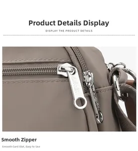 Detailed close-up of smooth dual metal zippers on a dark brown waterproof nylon bag