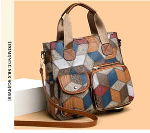 Detail of color-block geometric tote bag with textured leather and dual front pockets