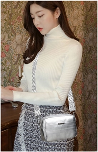 Silver square crossbody bag detail with metallic texture and geometric wide strap