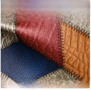 Detail of multi-color patchwork leather with litchi texture and contrast stitching