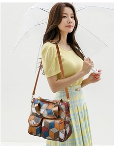 Asian model wearing a colorful geometric patchwork shoulder bag with leather straps