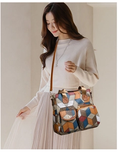 Detailed close-up of 3D geometric pattern crossbody bag with multiple front pockets