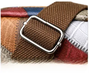 Close-up of multicolored leather patchwork bag with adjustable silver metal buckle