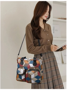 Detail view of the colorful geometric pattern and functional front pockets on the tote bag