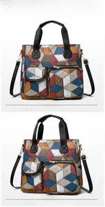 Detailed view of colorful 3D geometric tote bag with textured faux leather and gold zippers