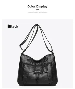 Close-up of black washed leather crossbody bag with multiple functional front zippers