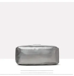 Detailed view of silver metallic bag bottom showing textured material and triple stitching