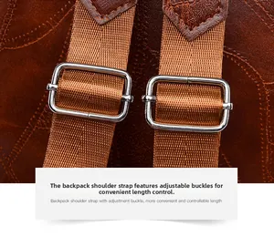 Detail of adjustable shoulder strap with silver buckle on brown lychee leather backpack