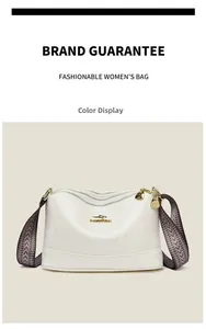 Detail view of white crossbody bag featuring triple zippers and gold kangaroo emblem