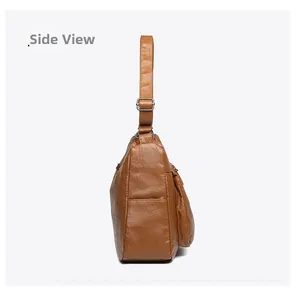 Side view of brown washed soft leather crossbody bag with adjustable wide strap and silver buckle