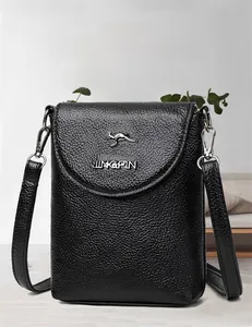 Detail of black lychee grain leather phone bag with silver kangaroo logo and adjustable strap