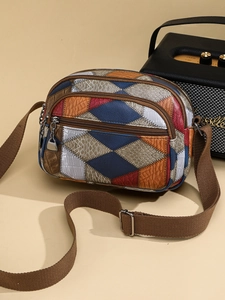 Vintage patchwork leather crossbody bag with multi-zipper layers and animal textures