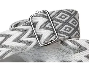 Close-up of geometric wave pattern woven strap with silver adjustable metal buckle