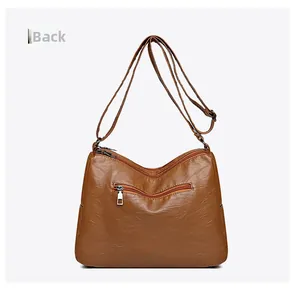 Rear view of brown washed PU leather crossbody bag featuring a horizontal zipper pocket
