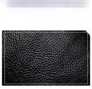 Detail of high-quality black lychee pattern PU leather with soft textured finish