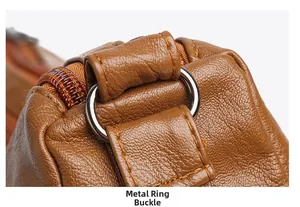 Detail of silver metal hardware ring and neat stitching on brown washed leather bag