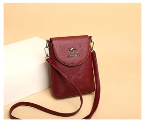 Detail of dark red lychee grain leather phone bag with metallic kangaroo logo and strap