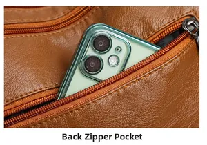 Detailed view of back zipper pocket on brown pebbled leather crossbody bag with smartphone