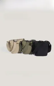Nylon hobo bags in beige, olive, and black with wide adjustable straps and sleek crescent design