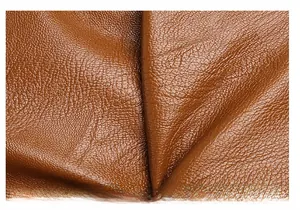 Macro detail of caramel brown washed soft leather with a natural lychee grain texture