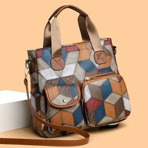 Vintage washed leather patchwork tote bag with geometric design and adjustable shoulder strap