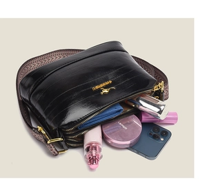 Top view of black multi-compartment crossbody bag showing spacious storage and wide strap