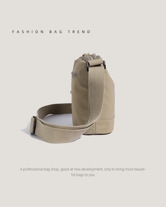 Detailed side profile of a khaki nylon bucket bag showing its thick texture and strap