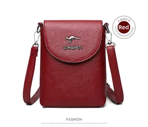 Detail of red litchi texture leather phone bag with kangaroo metal logo and strap