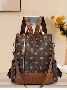 Detail of vintage brown patterned backpack with side pocket and caramel leather trim