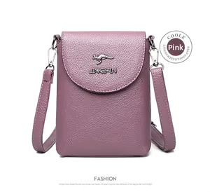 Detail of pink crossbody phone bag with litchi grain texture and metal kangaroo logo