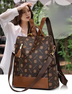 Detail of vintage brown printed backpack showing PU leather texture and metal zipper