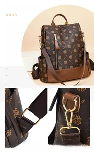 Detail view of the vintage brown leather backpack's adjustable fabric shoulder straps